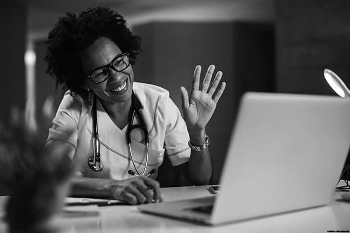 A provider waving hello at the start of a secure video visit